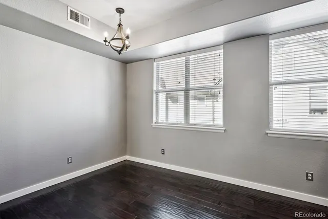 a window in an empty room with wooden floor