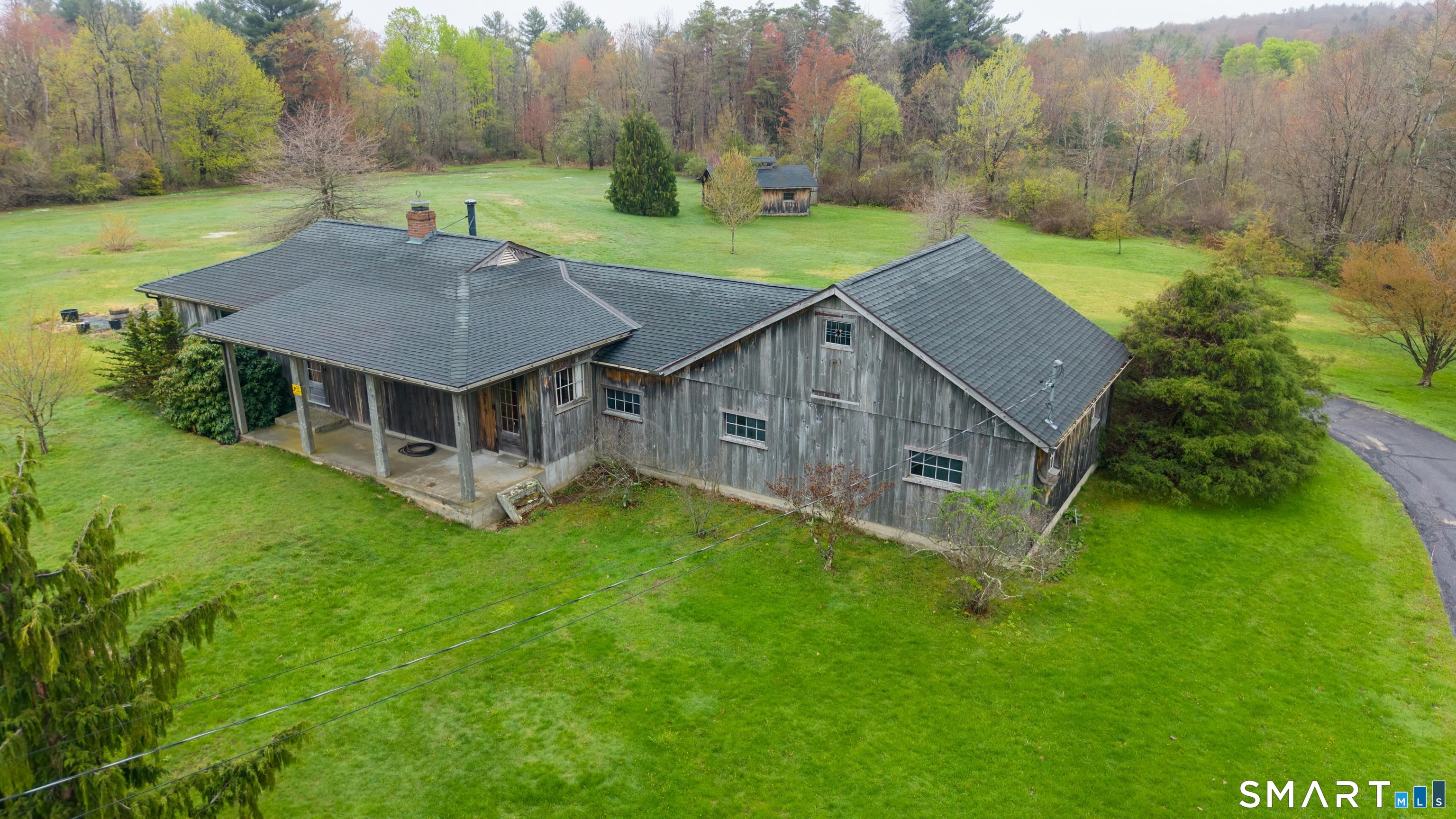 139 West Side Road Goshen, CT 06756 - Photo 1 of 17 a aerial view of a house with a yard table and chairs