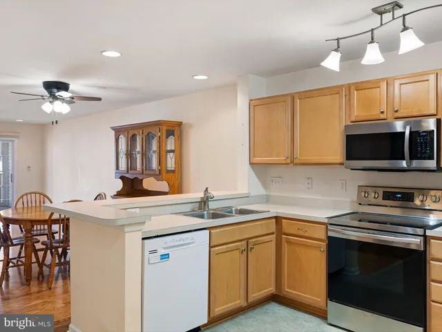 a kitchen with a stove a sink and a microwave