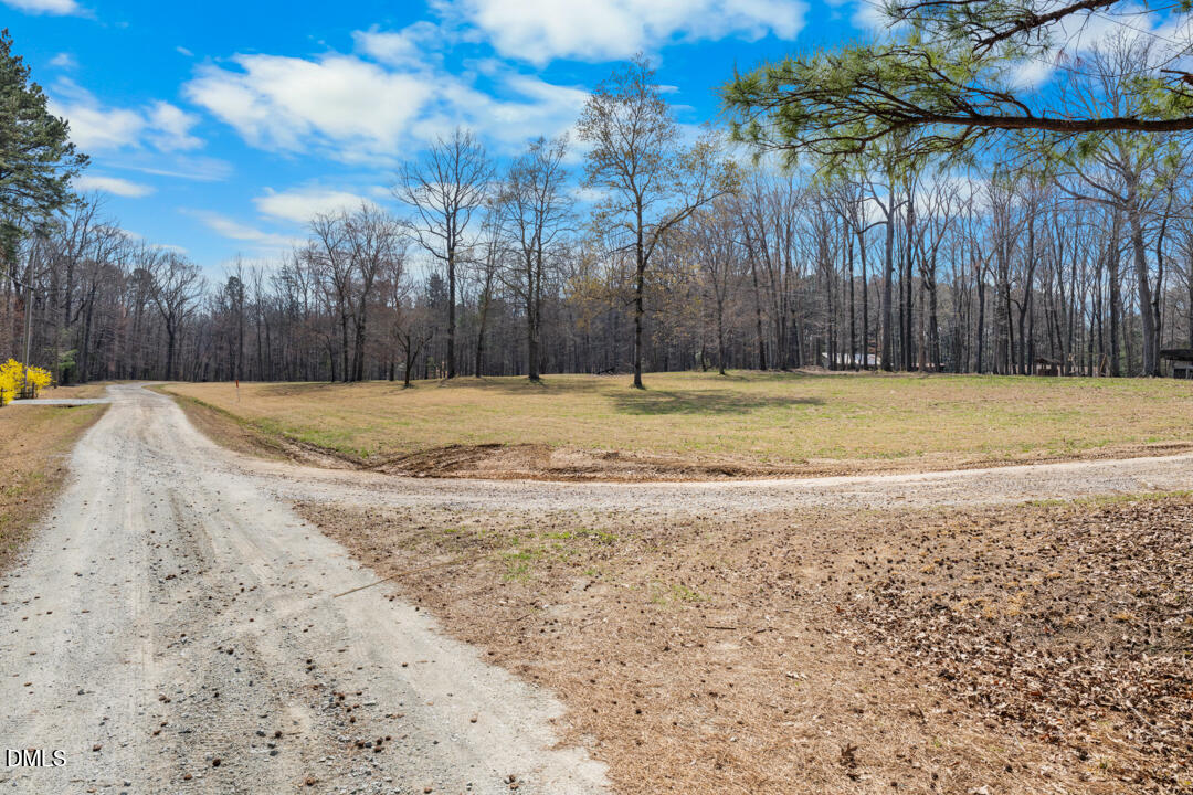 4739 Wild Azalea Place Rougemont, NC 27572 - Photo 4 of 48 a view of a yard with wooden fence