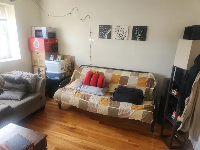 a bedroom with a bed and flat screen tv