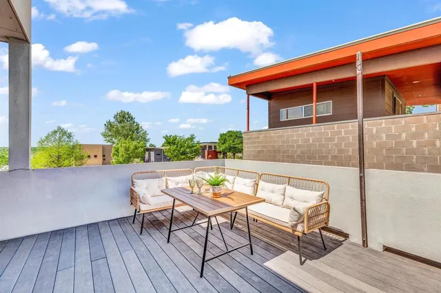 a backyard of a house with table and chairs