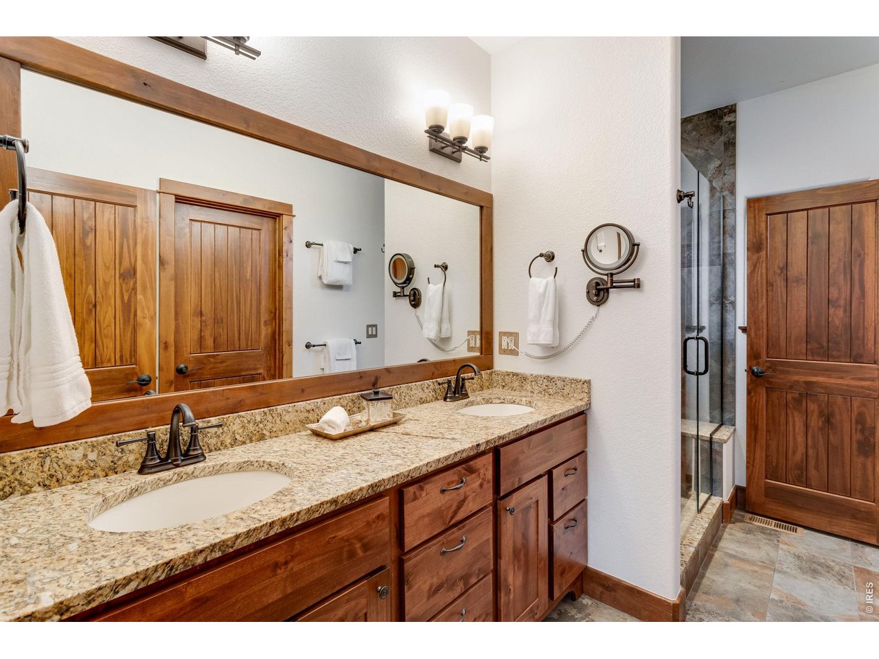 1127 Fish Creek Road Estes Park, CO 80517 - Photo 28 of 50 Primary bathroom with double sinks.