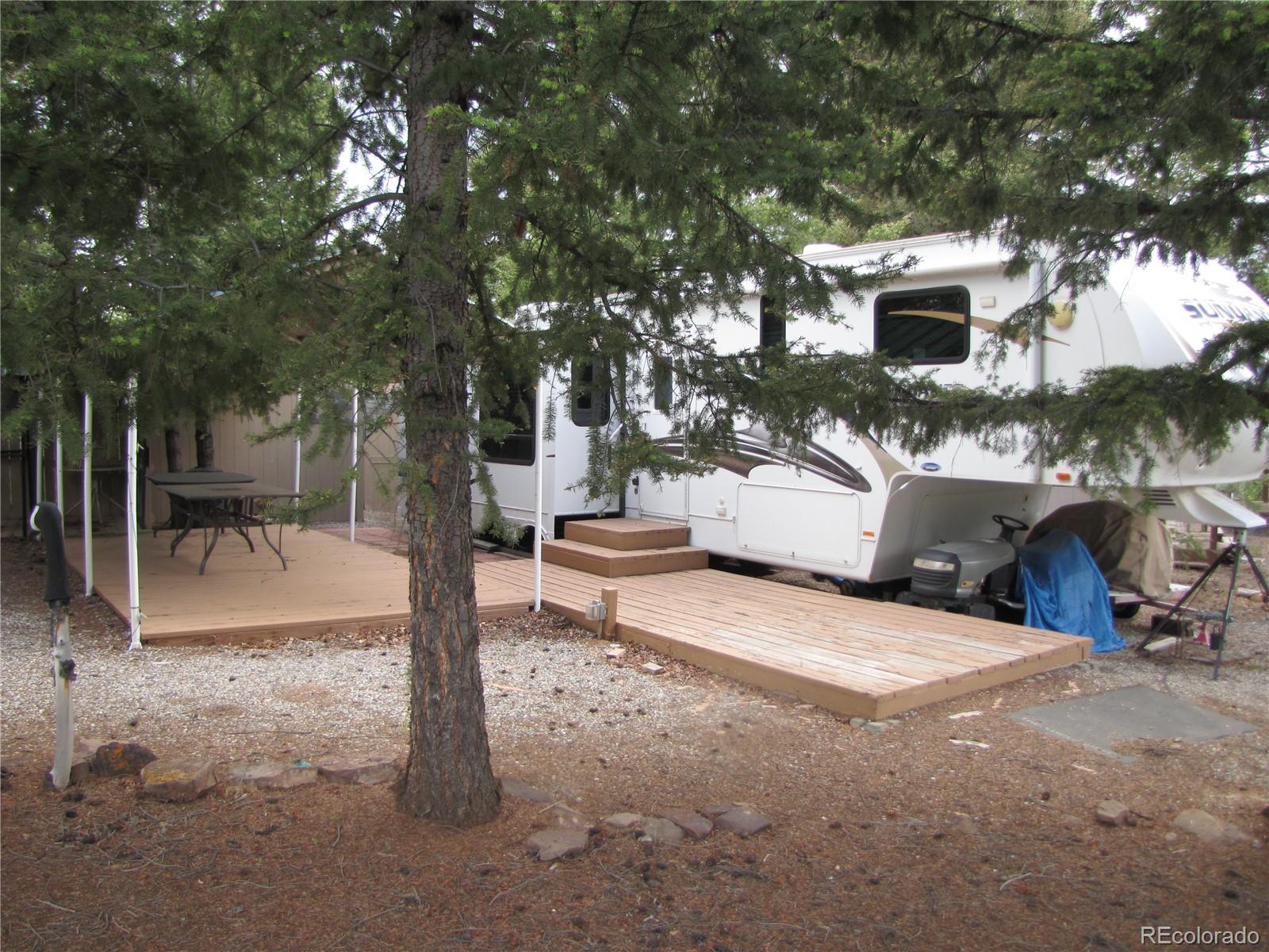 540 Lantern Loop Fairplay, CO 80440 - Photo 2 of 24 a view of a patio with table and chairs with a large tree