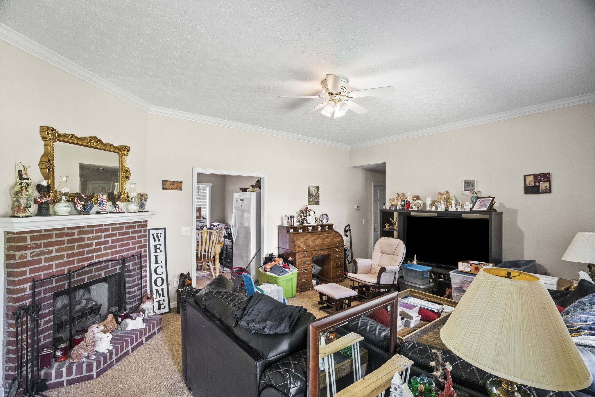 7324 Chowning Road Springfield, TN 37172 - Photo 8 of 30 a living room with furniture a fireplace and a flat screen tv