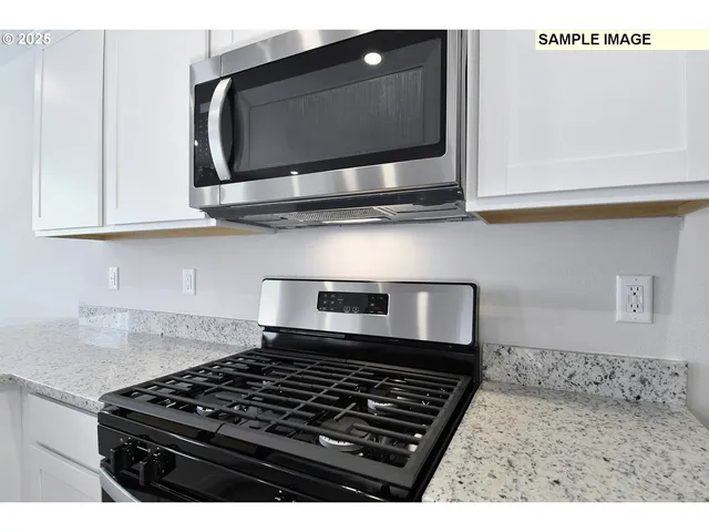 a kitchen with a sink cabinets and window