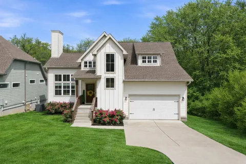 a front view of a house with a garden and plants