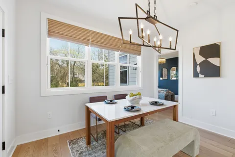 a view of a dining room with a table and chairs
