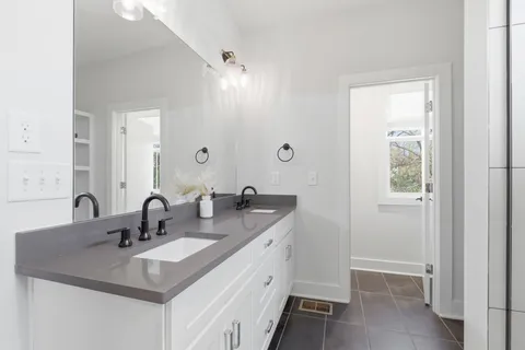 a bathroom with a sink double vanity and a mirror