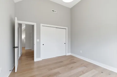 a view of an empty room with wooden floor