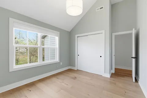 an empty room with windows and closet