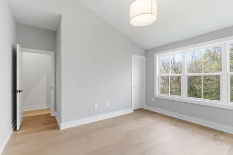 an empty room with windows and closet