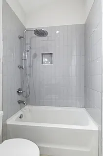 a bathroom with a bathtub and a toilet
