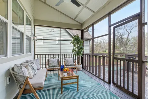 a balcony with furniture and wooden floor
