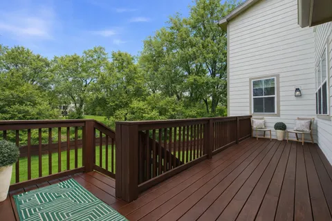 a view of a wooden deck with a yard
