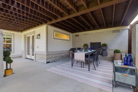 a view of a roof deck with table and chairs
