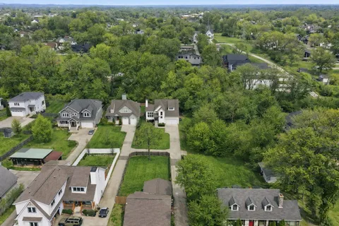 an aerial view of a house with a garden and trees