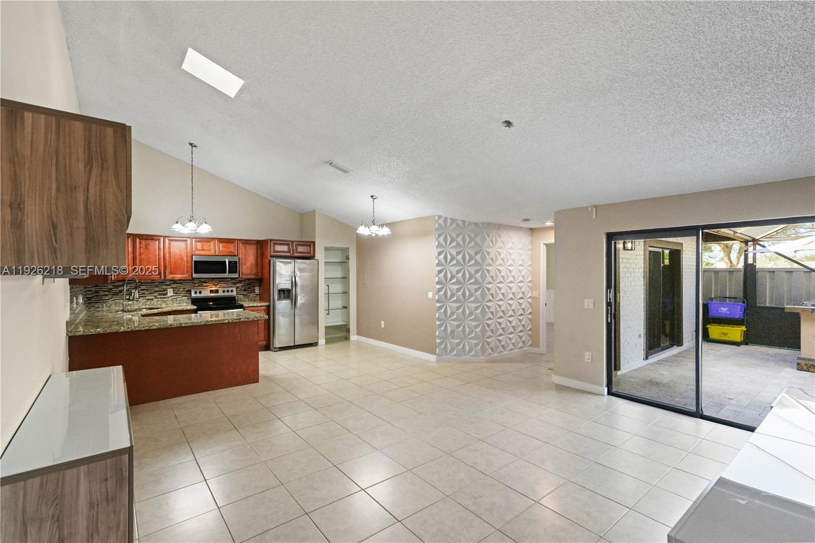 9568 Boca Gardens Parkway, Unit B Boca Raton, FL 33496 - Photo 18 of 71 a large kitchen with stainless steel appliances kitchen island granite countertop a refrigerator and a stove