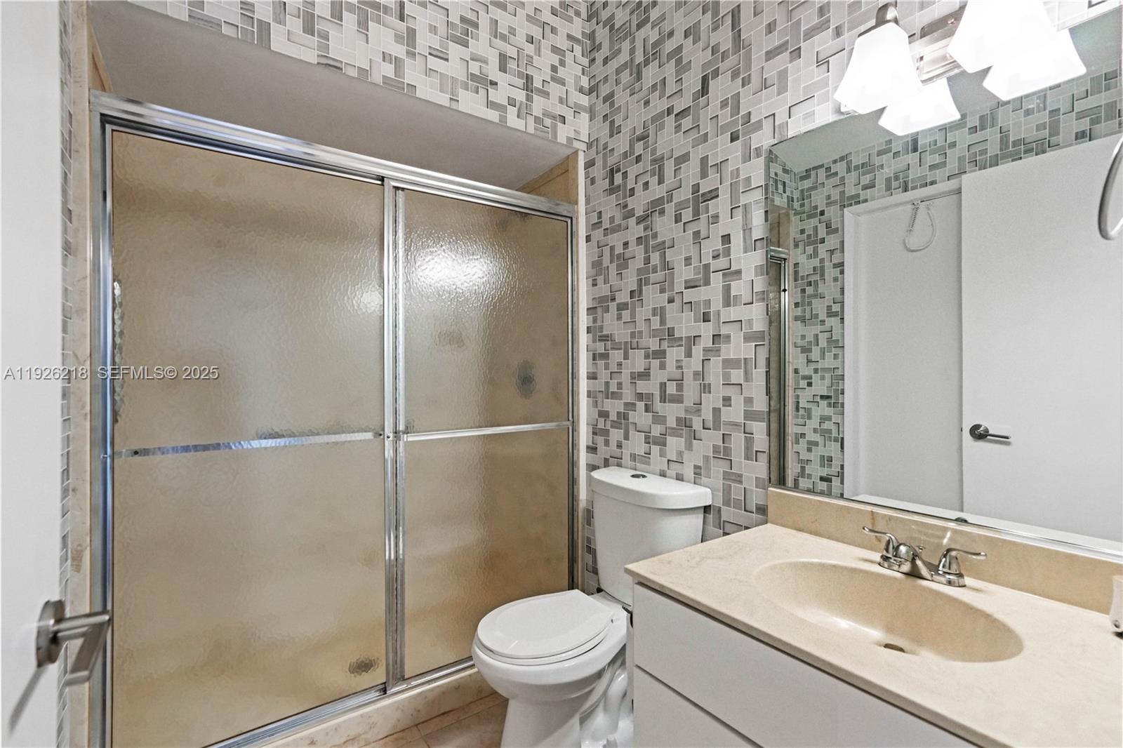 9568 Boca Gardens Parkway, Unit B Boca Raton, FL 33496 - Photo 32 of 71 a bathroom with a granite countertop sink toilet and shower