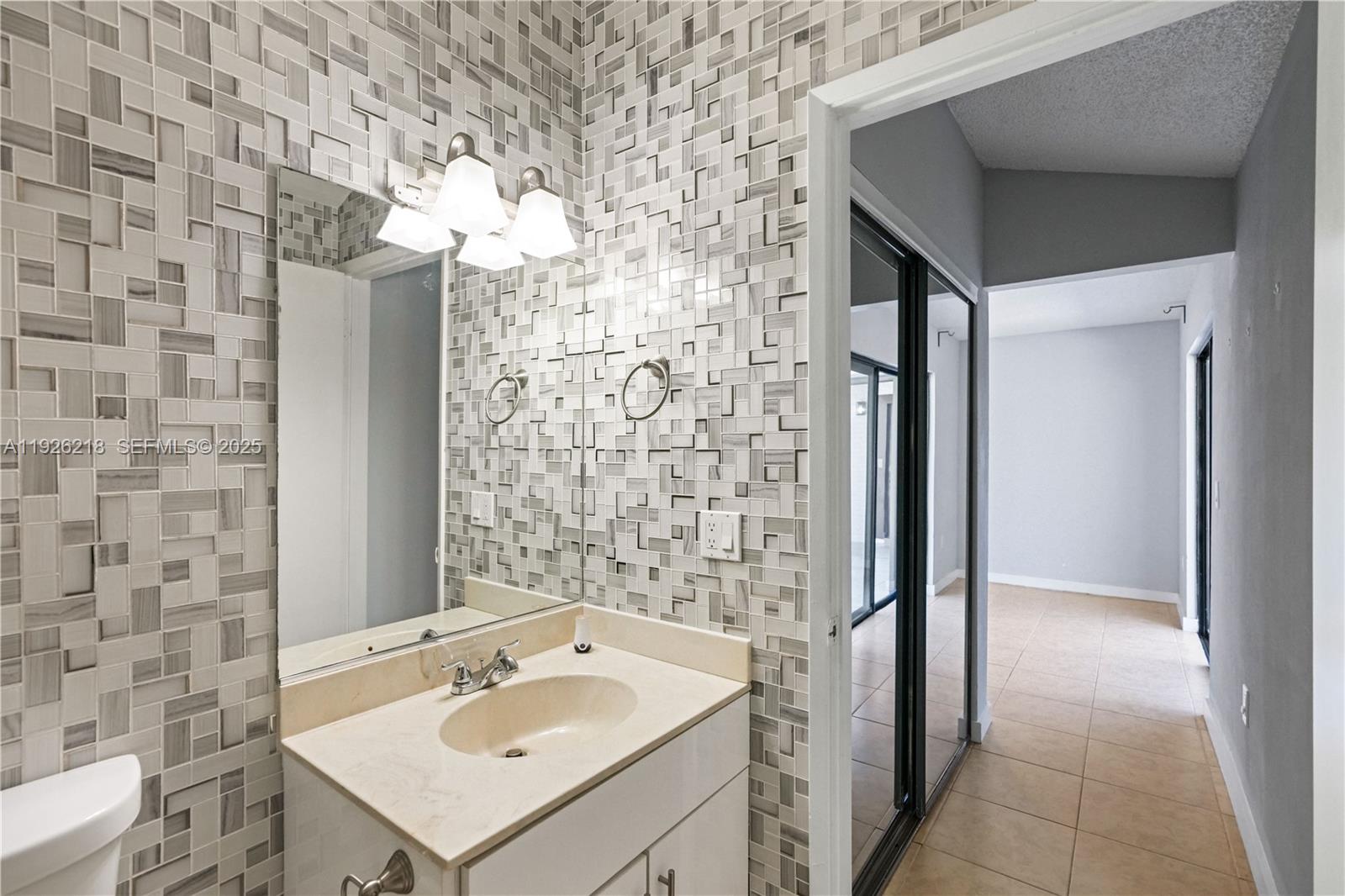9568 Boca Gardens Parkway, Unit B Boca Raton, FL 33496 - Photo 33 of 71 a bathroom with a sink and a mirror