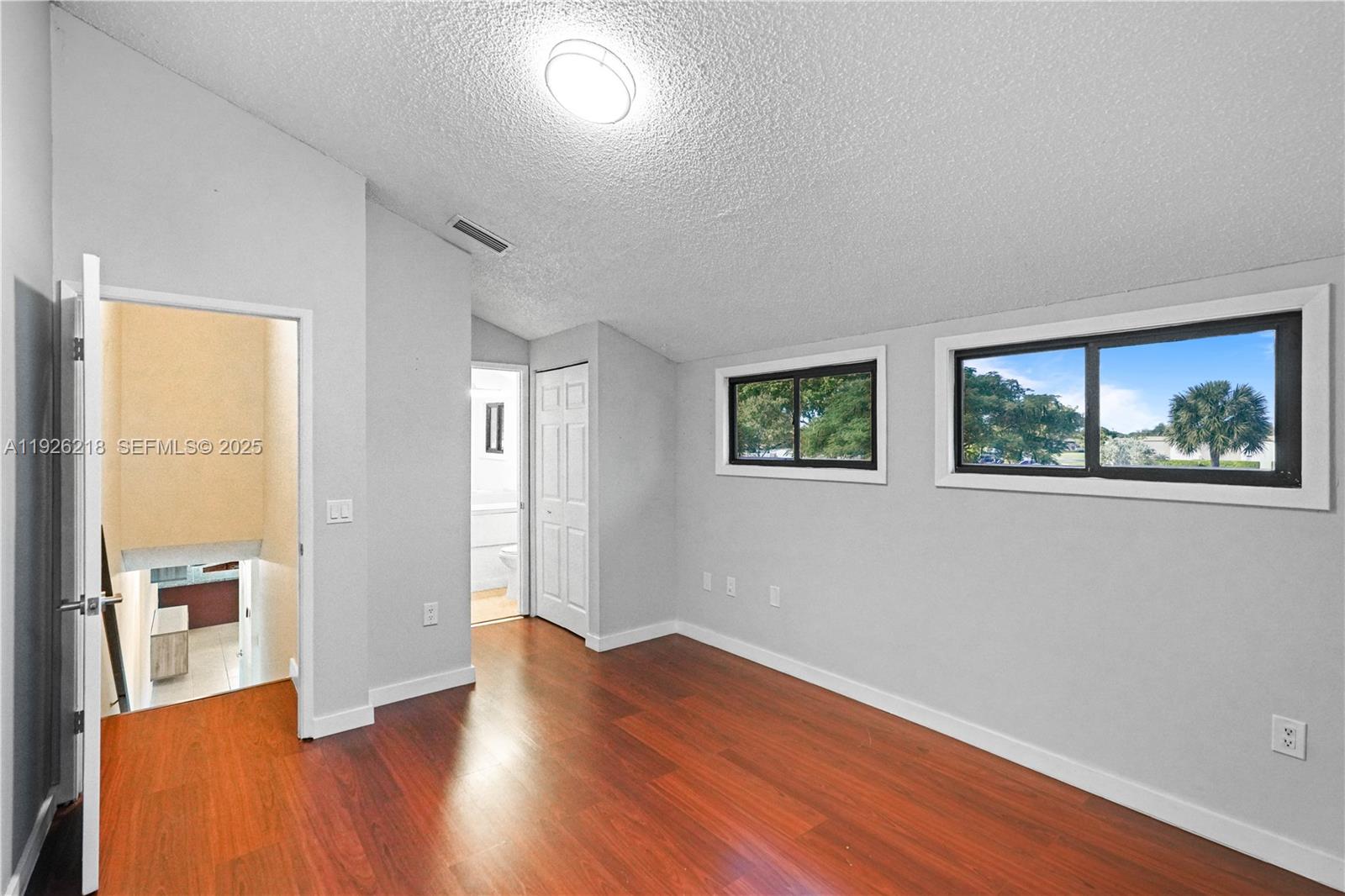 9568 Boca Gardens Parkway, Unit B Boca Raton, FL 33496 - Photo 36 of 71 wooden floor in an empty room with a window