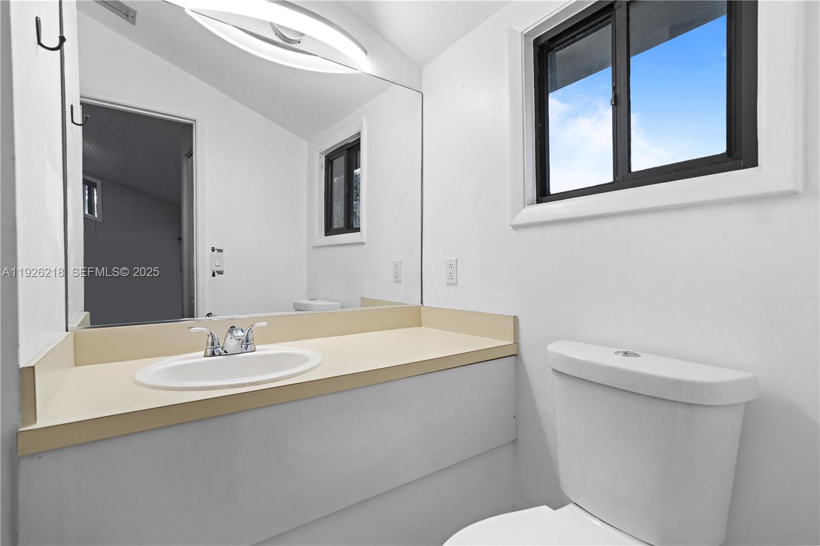 9568 Boca Gardens Parkway, Unit B Boca Raton, FL 33496 - Photo 39 of 71 a bathroom with a sink a toilet and mirror