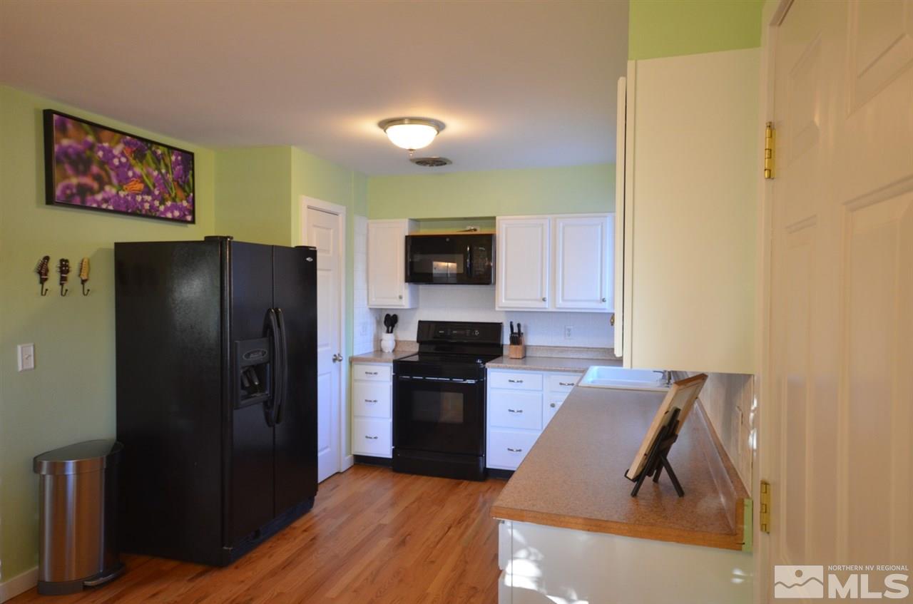 525 Ballentyne Way Reno, NV 89502 - Photo 3 of 22 a kitchen with stainless steel appliances granite countertop a refrigerator and a stove