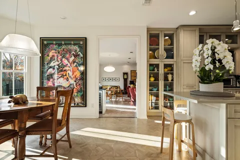 a view of a dining room with furniture and chandelier