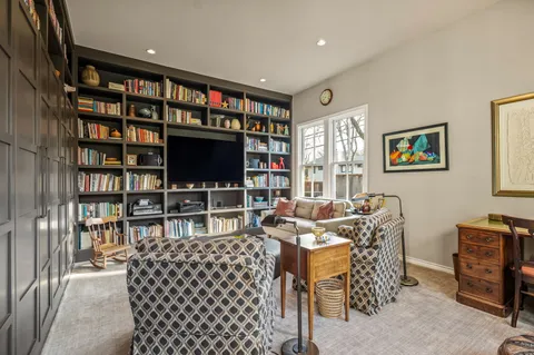 a living room with fireplace furniture and a flat screen tv