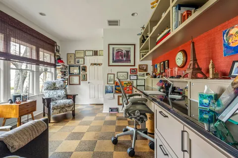 a very nice looking room with many windows and furniture