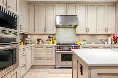 a kitchen with stainless steel appliances granite countertop a stove and a sink