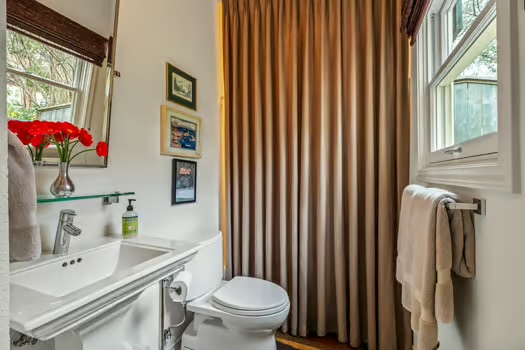 311 Ridgewood Road Austin, TX 78746 - Photo 22 of 38 a bathroom with a sink toilet and shower