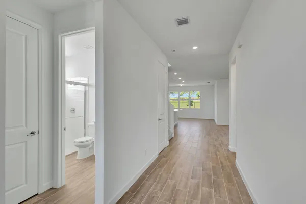 a view of an empty room and wooden floor
