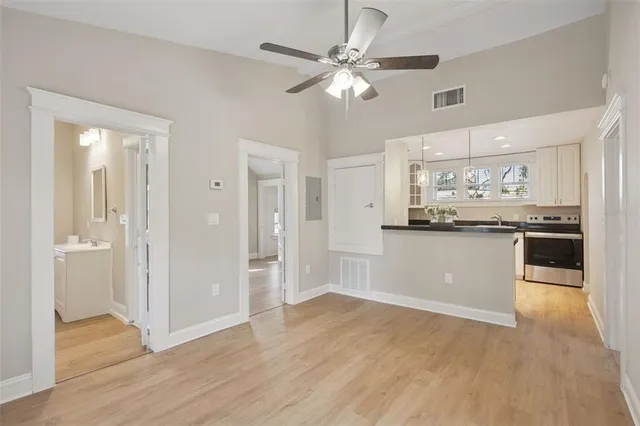 a view of a kitchen with a sink a refrigerator and window