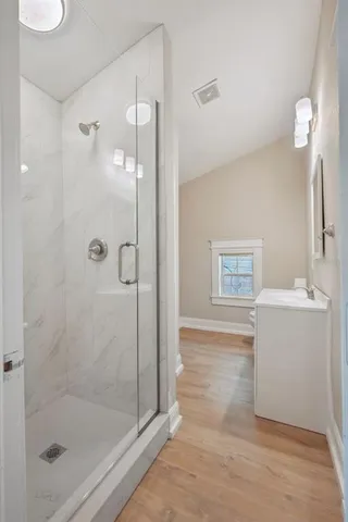 a bathroom with a shower and a sink