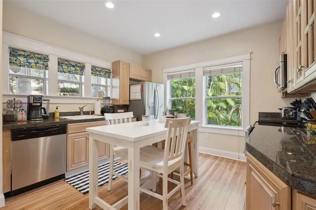 a kitchen with a sink stove and wooden floor