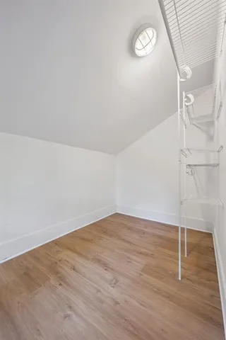 a view of a room with wooden floor
