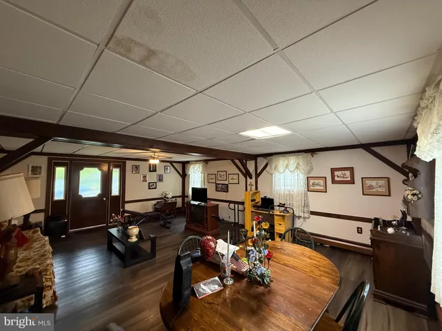a living room with furniture a wooden floor and a window