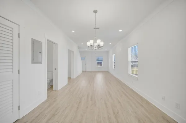 a view of an empty room with wooden floor