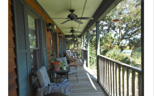 97030 Pirates Point Road Yulee, FL 32097 - Photo 22 of 24 a view of a porch with chairs and backyard