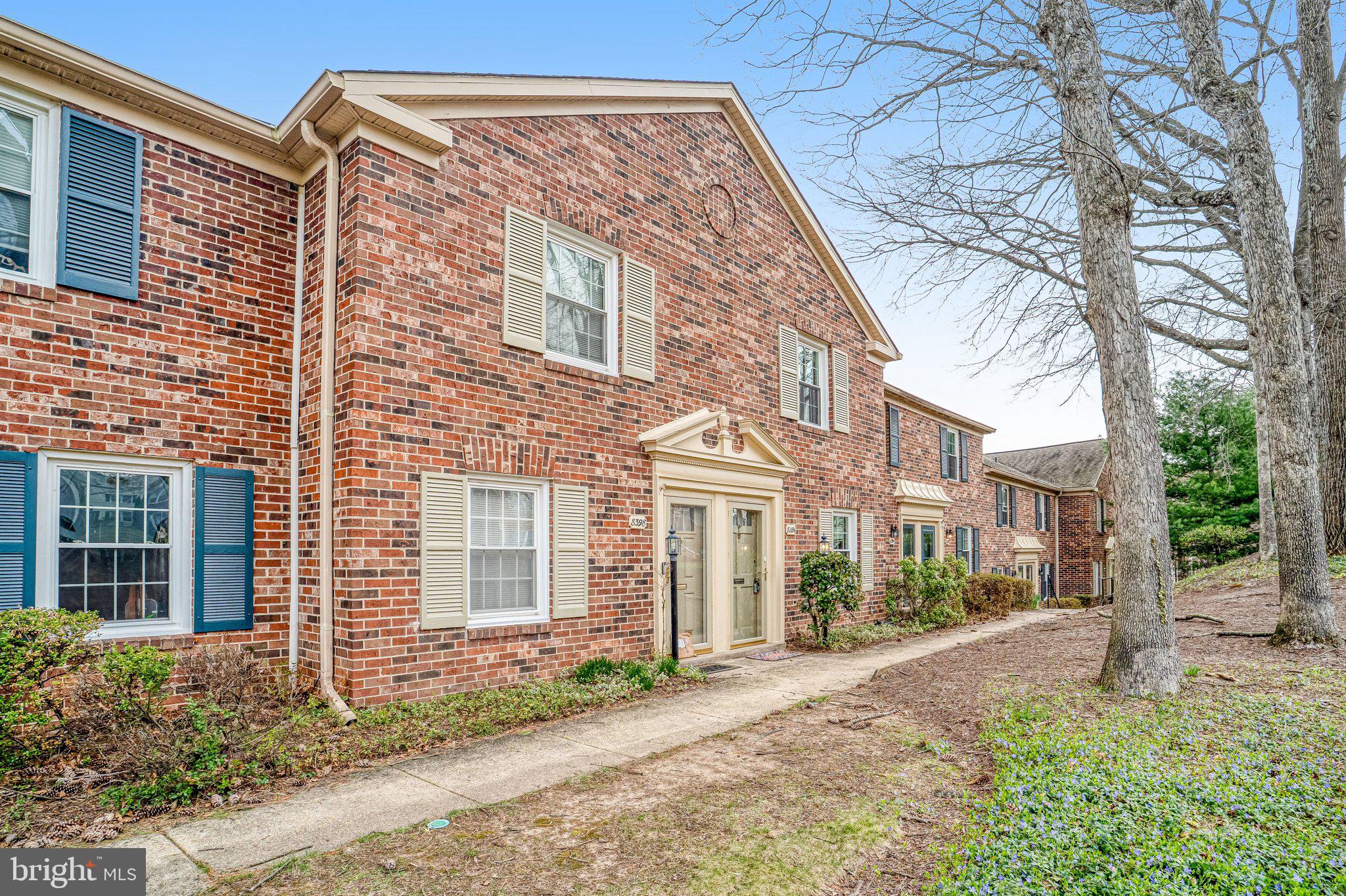 8396 Forrester Boulevard, Unit 555 Springfield, VA 22152 - Photo 1 of 24 a view of a brick house with a yard