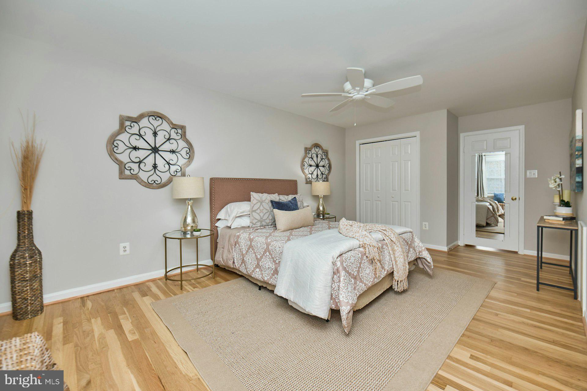 1120 Kensington Road McLean, VA 22101 - Photo 19 of 47 a spacious bedroom with a bed and a chandelier