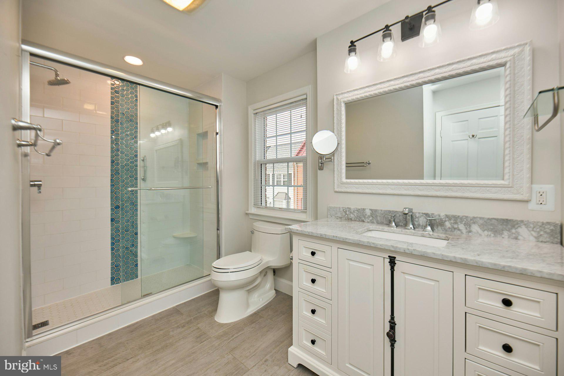 1120 Kensington Road McLean, VA 22101 - Photo 21 of 47 a bathroom with a granite countertop sink toilet and shower