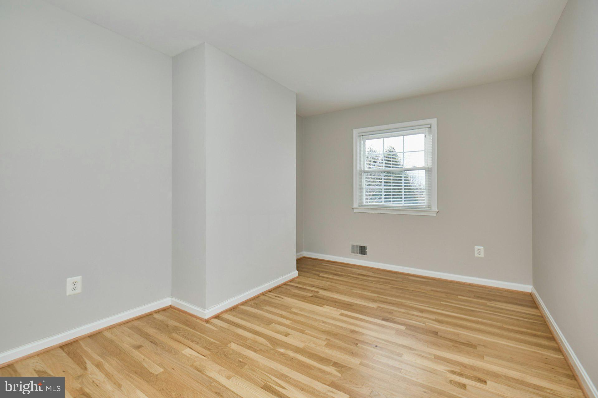 1120 Kensington Road McLean, VA 22101 - Photo 22 of 47 a view of an empty room with wooden floor and a window