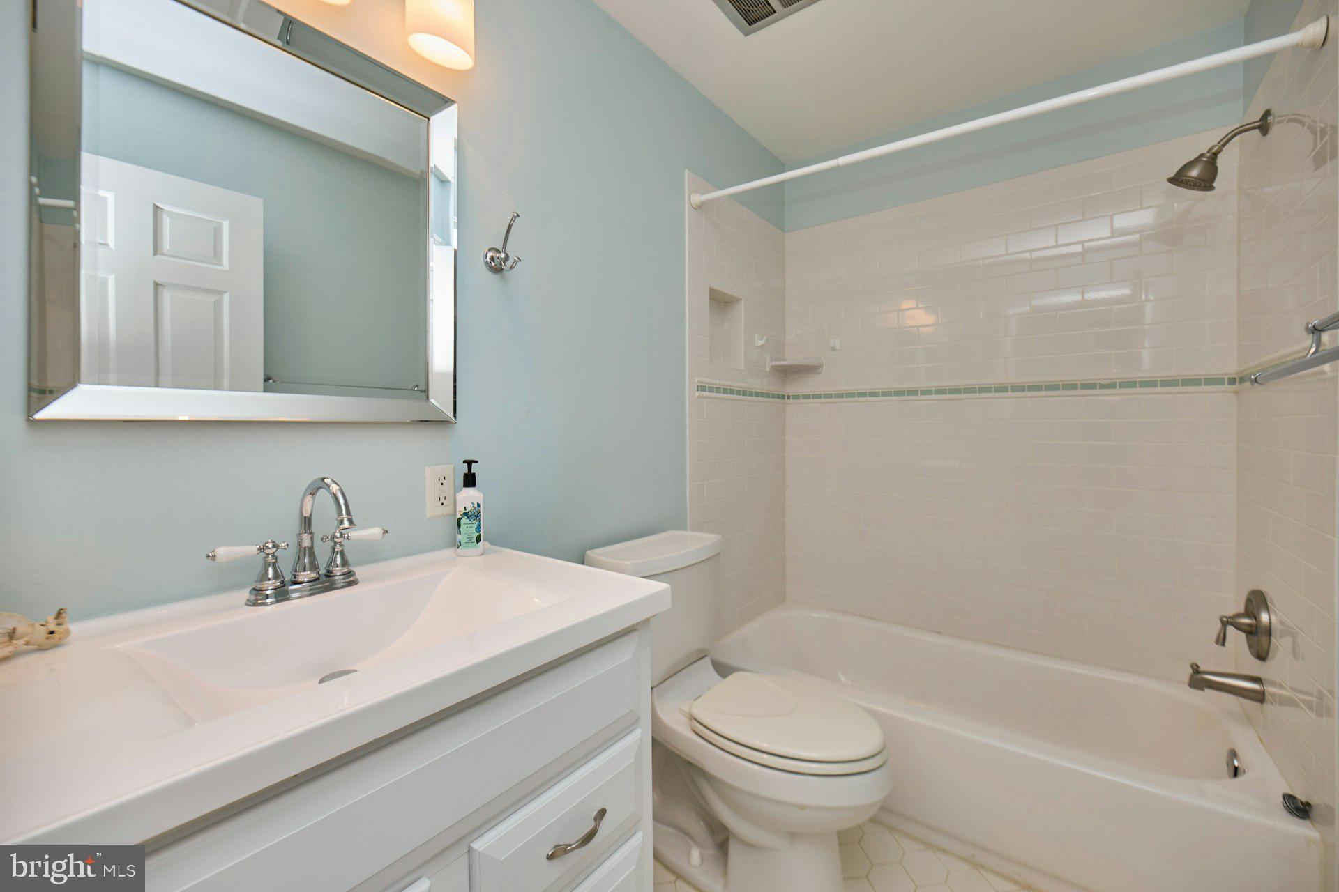 1120 Kensington Road McLean, VA 22101 - Photo 24 of 47 a bathroom with a sink a toilet and a bathtub