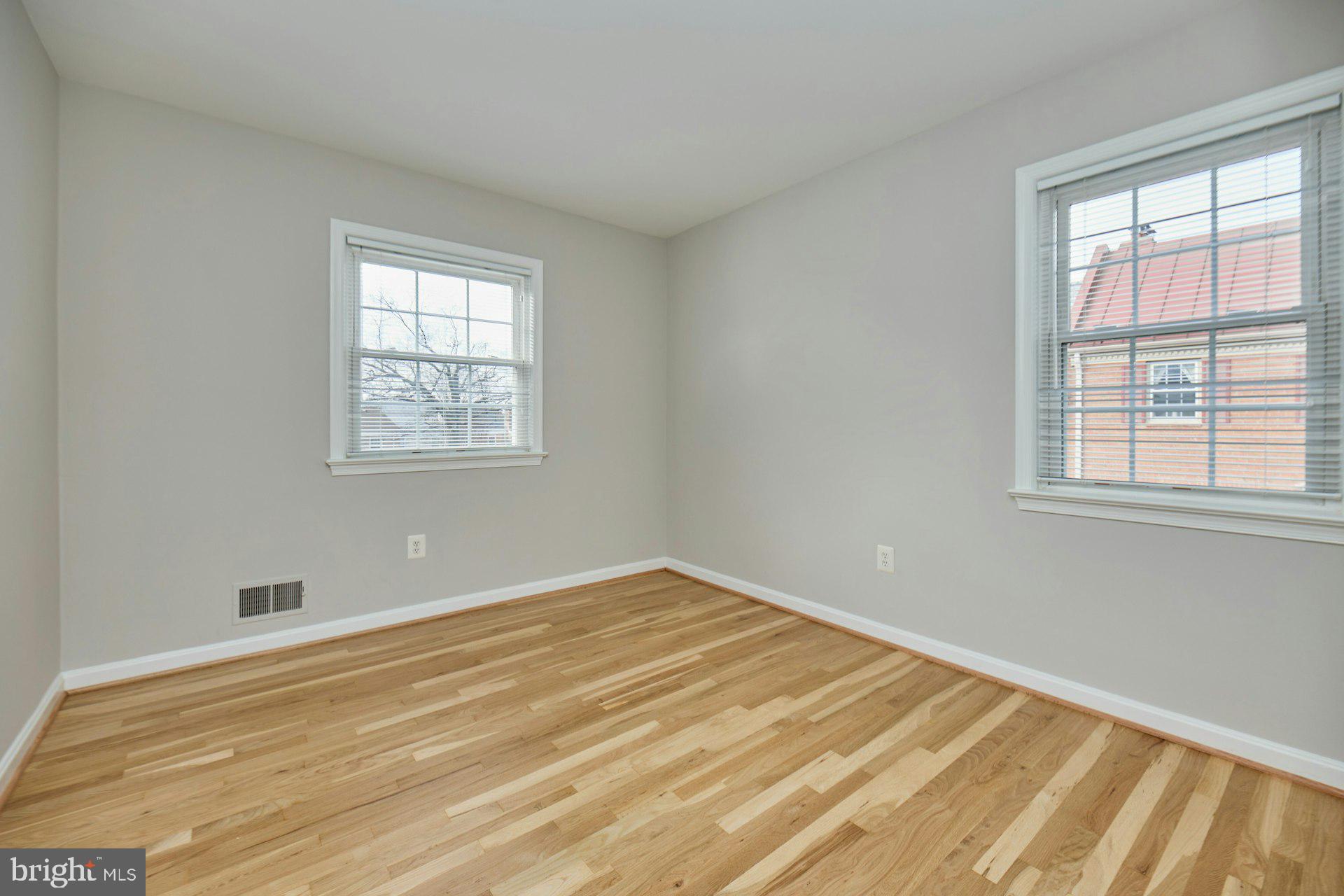 1120 Kensington Road McLean, VA 22101 - Photo 25 of 47 a view of an empty room with wooden floor and a window