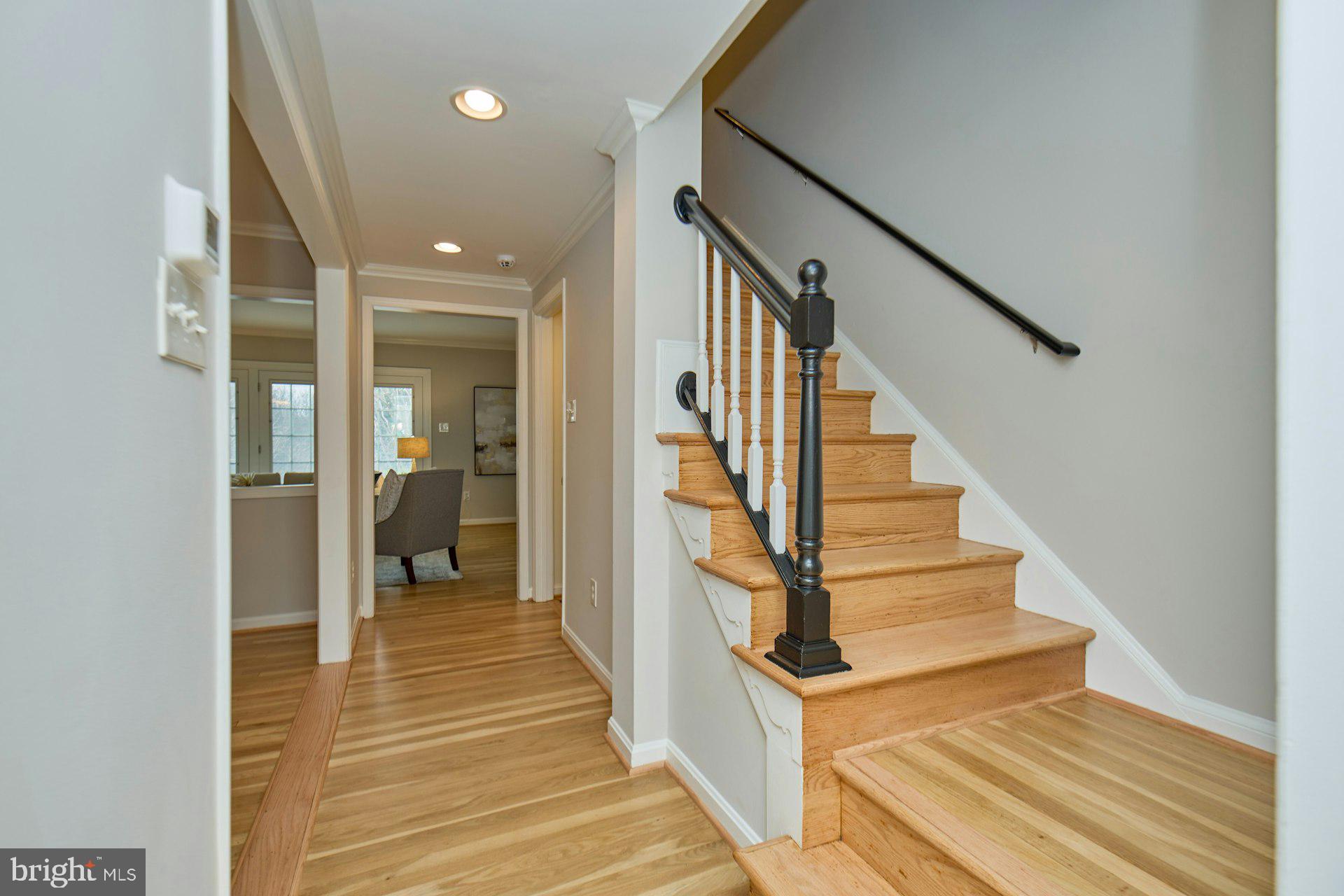 1120 Kensington Road McLean, VA 22101 - Photo 6 of 47 a view of a hallway with wooden floor and staircase