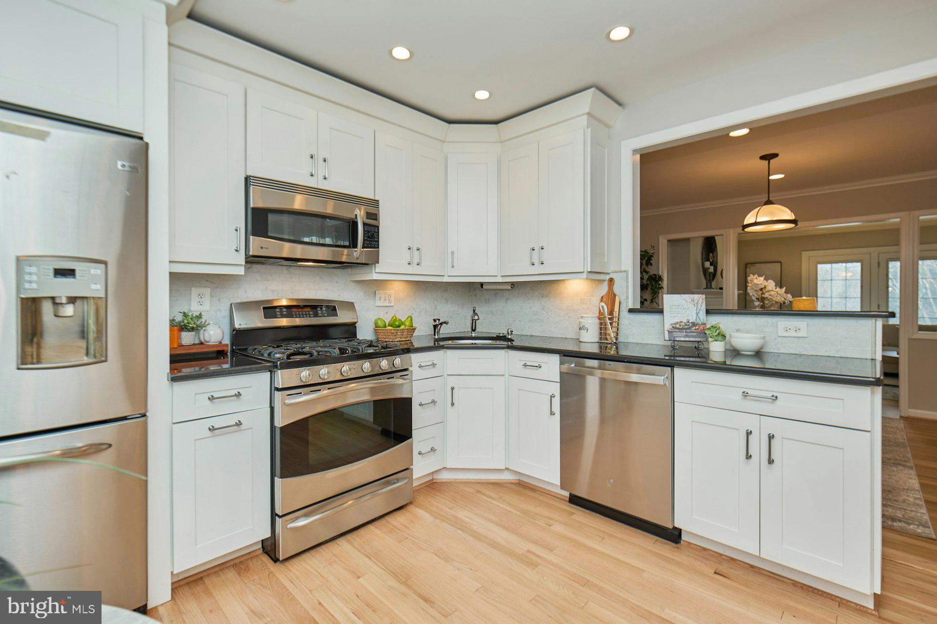 1120 Kensington Road McLean, VA 22101 - Photo 9 of 47 a kitchen with white cabinets stainless steel appliances and sink