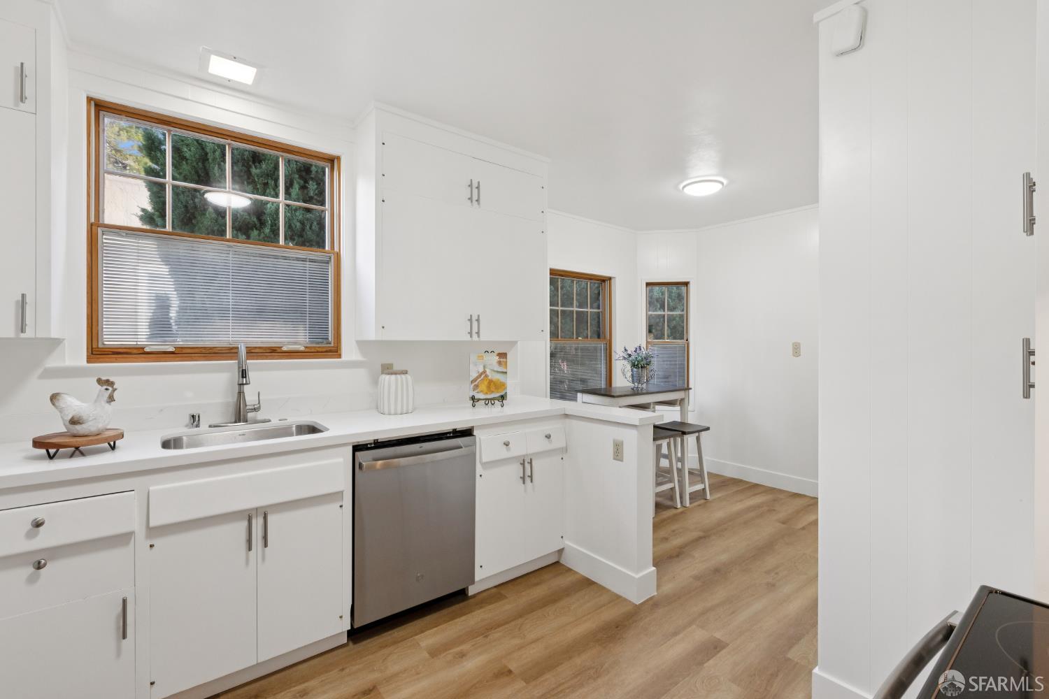 1316 Castillo Avenue Burlingame, CA 94010 - Photo 10 of 33 a kitchen with a sink cabinets and wooden floor