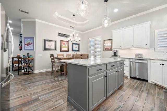 a spacious bedroom with a bed and ceiling fan